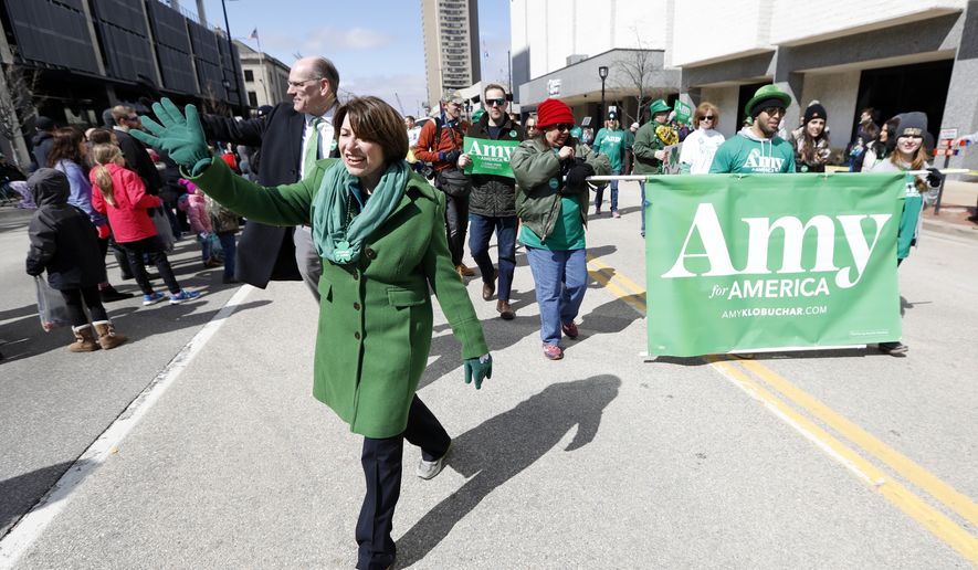 2020 Democratic presidential candidate Sen. Amy Klobuchar waves as she walks in the St. Patrick&#39;s Day Parade, Sunday, March 17, 2019, in Cedar Rapids, Iowa. (AP Photo/Charlie Neibergall)