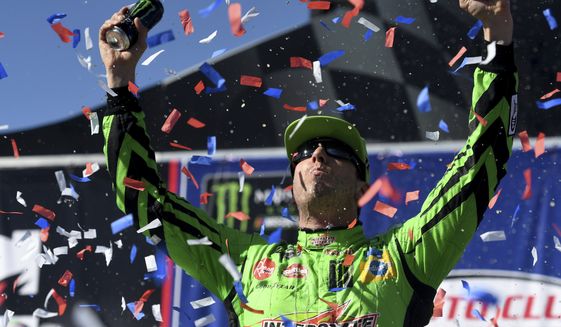 Kyle Busch celebrates after winning the NASCAR Cup Series auto race at Auto Club Speedway in Fontana, Calif., Sunday, March 17, 2019. (James Quigg/The Daily Press via AP)