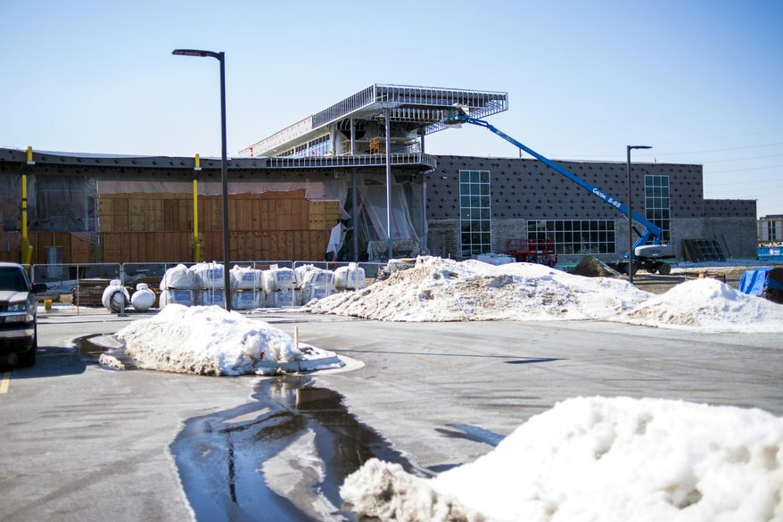 This May 8, 2019 photo shows construction at the Flint Cultural Center Academy in Flint, Mich. Enrollment is expected to begin at about 300 students. The academy could expand to as many as 650 students after sixth, seventh and eighth grades are added in coming years. (Jake May/The Flint Journal via AP)