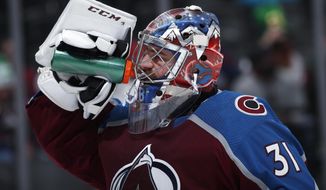 Colorado Avalanche goaltender Philipp Grubauer takes a drink during a timeout during the second period of the team&#39;s NHL hockey game against the New Jersey Devils on Sunday, March 17, 2019, in Denver. (AP Photo/David Zalubowski)