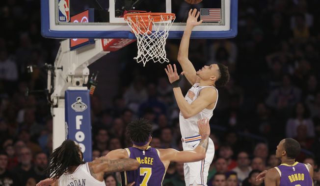 New York Knicks&#x27; Kevin Knox, top, scores during the first half of an NBA basketball game against the Los Angeles Lakers, Sunday, March 17, 2019, in New York. (AP Photo/Seth Wenig)