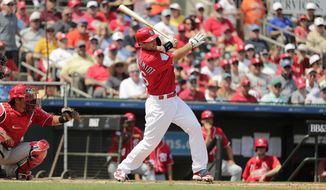 St. Louis Cardinals&#39; Paul Goldschmidt, center, hits a double in the third inning during an exhibition spring training baseball game against the Washington Nationals on Monday, March 11, 2019, in Jupiter, Fla. (AP Photo/Brynn Anderson)