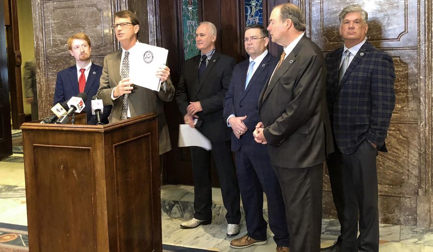 In this Wednesday, March 13, 2019 photo, Republican State Sen. Richard Cash of Powdersville holds up information about a bill he filed that would put more restrictions on abortion while other lawmakers who oppose abortions stand behind him at the South Carolina Statehouse in Columbia, S.C. South Carolina lawmakers have had little discussion about abortion in 2019 even as bans in other states move forward through their legislatures. (AP Photo / Jeffrey Collins)