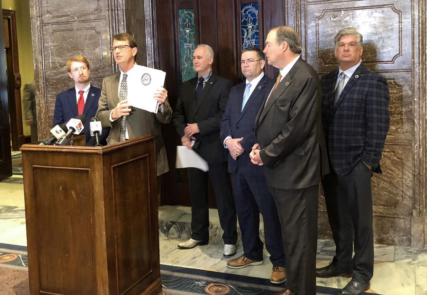 In this Wednesday, March 13, 2019 photo, Republican State Sen. Richard Cash of Powdersville holds up information about a bill he filed that would put more restrictions on abortion while other lawmakers who oppose abortions stand behind him at the South Carolina Statehouse in Columbia, S.C. South Carolina lawmakers have had little discussion about abortion in 2019 even as bans in other states move forward through their legislatures. (AP Photo / Jeffrey Collins)