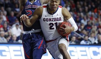 Gonzaga&#39;s Rui Hachimura drives into St. Mary&#39;s Malik Fitts during the first half of an NCAA college basketball game for the West Coast Conference men&#39;s tournament title, Tuesday, March 12, 2019, in Las Vegas. (AP Photo/John Locher)
