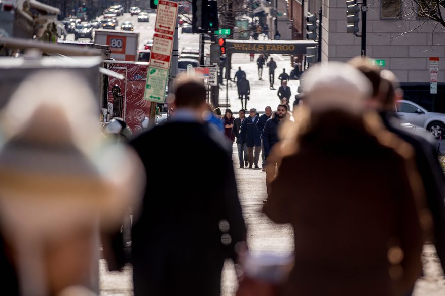 Workers stand in line at food trucks at lunchtime along K Street in downtown Washington, Monday, Jan. 28, 2019. The shutdown started in December over funding for President Donald Trump's promised U.S.-Mexico border wall. Trump on Friday agreed to end the shutdown for three weeks. (AP Photo/Andrew Harnik)