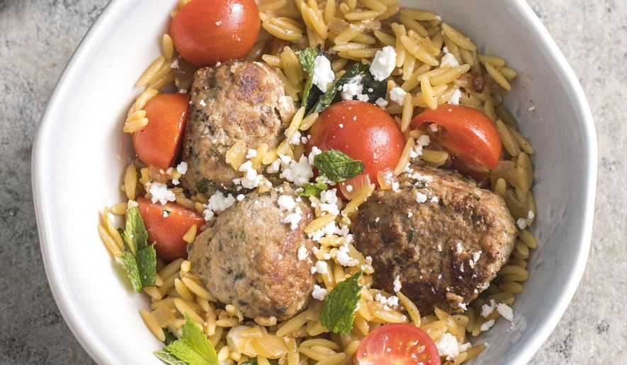 This undated photo provided by America's Test Kitchen in March 2019 shows Lamb Meatballs With Orzo in Brookline, Mass. This recipe appears in the book "Cook It In Your Dutch Oven." (Steve Klise/America's Test Kitchen via AP)