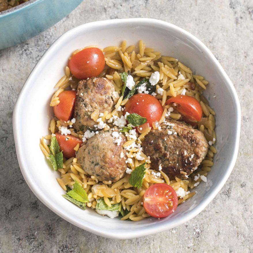 This undated photo provided by America's Test Kitchen in March 2019 shows Lamb Meatballs With Orzo in Brookline, Mass. This recipe appears in the book "Cook It In Your Dutch Oven." (Steve Klise/America's Test Kitchen via AP)