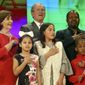 Former President George W. Bush and former first lady Laura Bush recite the pledge of allegiance with new U.S. citizens, including Felix Odeh, (top right) of Nigeria, during a naturalization ceremony at the George W. Bush Presidential Center in Dallas on Monday, March 18, 2019. Forty-nine people representing 20 countries became American citizens at the ceremony.  (Rose Baca/The Dallas Morning News via AP)