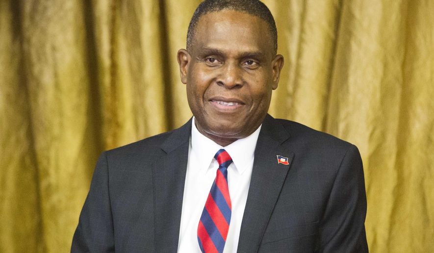 FILE - In this Aug. 7, 2018 file photo, Haiti's prime minister Jean-Henry Ceant sits during his appointment ceremony at the national Palace in Port-au-Prince, Haiti. Ceant has been thrown out of office by a no-confidence vote on Monday, March 18, 2019, prompted by government dysfunction and inability to quash inflation, blackouts and frequent opposition protests that have paralyzed the country. ( AP Photo/Dieu Nalio Chery, File)