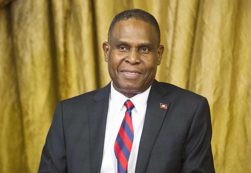 FILE - In this Aug. 7, 2018 file photo, Haiti's prime minister Jean-Henry Ceant sits during his appointment ceremony at the national Palace in Port-au-Prince, Haiti. Ceant has been thrown out of office by a no-confidence vote on Monday, March 18, 2019, prompted by government dysfunction and inability to quash inflation, blackouts and frequent opposition protests that have paralyzed the country. ( AP Photo/Dieu Nalio Chery, File)
