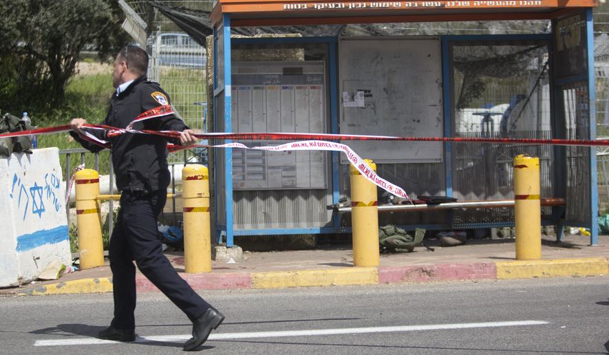 An Israeli police officer is seen at the scene of an attack near the West Bank Jewish settlement of Ariel, Sunday, March 17, 2019.The Israeli military says a Palestinian killed an Israeli and seriously wounded two others in a West Bank shooting and stabbing spree before fleeing and setting off a massive manhunt. (AP Photo/Sebastian Scheiner)