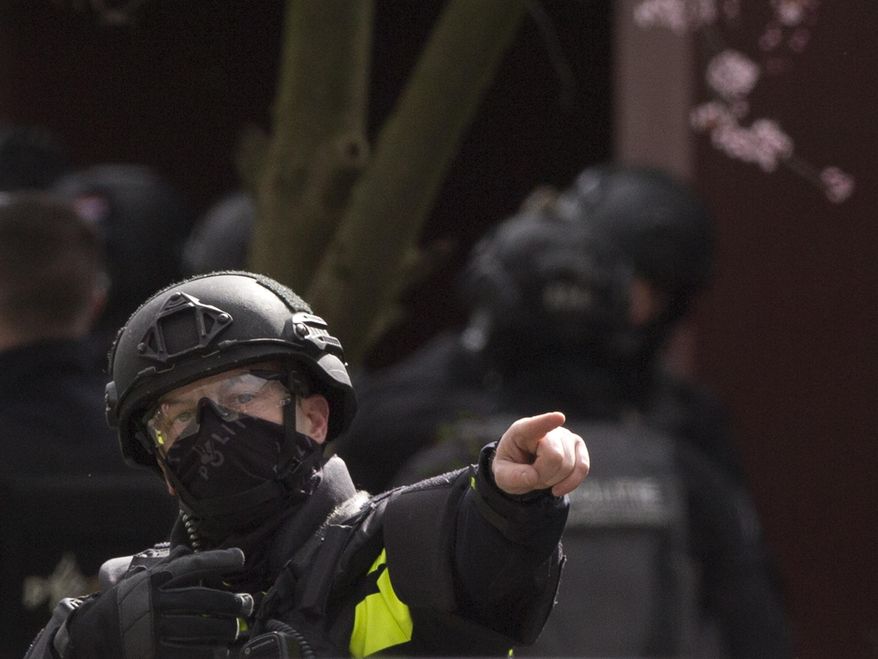 Dutch counter terrorism police prepare to enter a house after a shooting incident in Utrecht, Netherlands, Monday, March 18, 2019. A gunman killed three people and wounded nine others on a tram in the central Dutch city of Utrecht, sparking a manhunt that saw heavily armed officers with sniffer dogs zero in on an apartment building close to the shooting. (AP Photo/Peter Dejong)