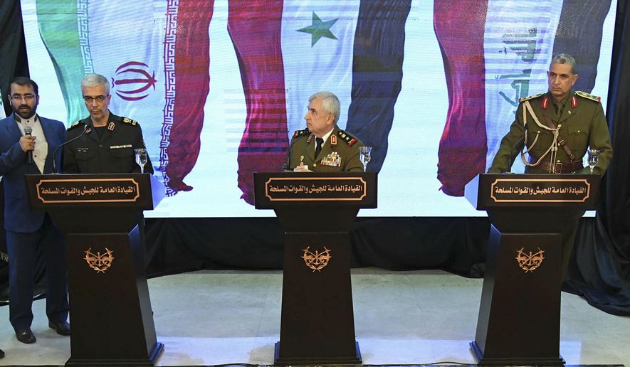 In this photo released by the Syrian official news agency SANA, Iran's Chief of Staff of Armed Forces, Maj. Gen. Mohammad Hossein Bagheri, left, speaks during a press conference with Syria's defense minister Gen. Ali Ayoub, center, and Iraqi army commander, Gen. Osman Ghanemi in Damascus, Syria, Monday, March 18, 2019. Syria's defense minister slammed what he called the "illegitimate" U.S. military presence in his country, vowing that Syria has a right to self-defense. (SANA via AP)