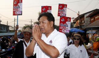 In this March 14, 2019, photo, Veerawit Chuajunud, center, who changed his name to Thaksin Chuajunud for Pheu Chart party, makes his election campaign in Nakhon Ratchasima, Thailand. Thailand’s former Prime Minister Thaksin Shinawatra is in exile and banned from interfering in the country’s politics. But his name is a powerful political attraction and in tribute, and to win votes, some candidates in general election on Sunday, March 24, 2019 have changed their names to Thaksin so supporters of the former leader can register their loyalty at the ballot box. (AP Photo/Sakchai Lalit)