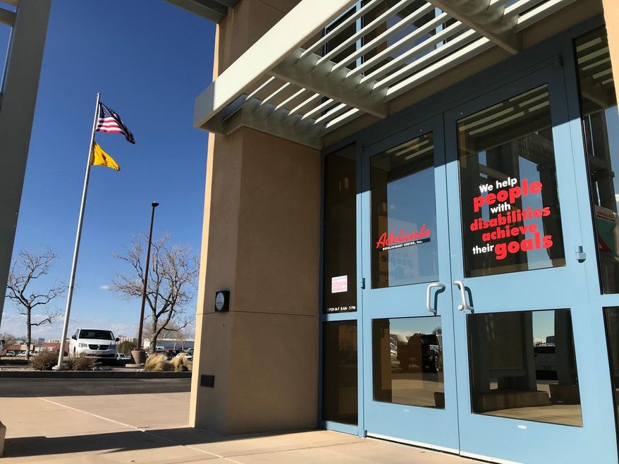 This March 18, 2019 image shows the entrance to the Adelante Development Center in Albuquerque, New Mexico. The state attorney general's office announced Monday that it was investigating allegations that the nonprofit organization, which helps people with developmental disabilities find jobs, was underpaying workers. The organization said it welcomes the attorney general's review of labor laws that govern pay for workers within the disability community. (AP Photo/Susan Montoya Bryan)
