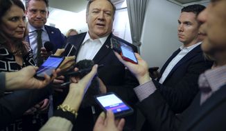 Secretary of State Mike Pompeo, centers, speaks to the media on his plane after departing Kansas City, Missouri, Monday, March 18, 2019. (Jim Young/Pool Image via AP)