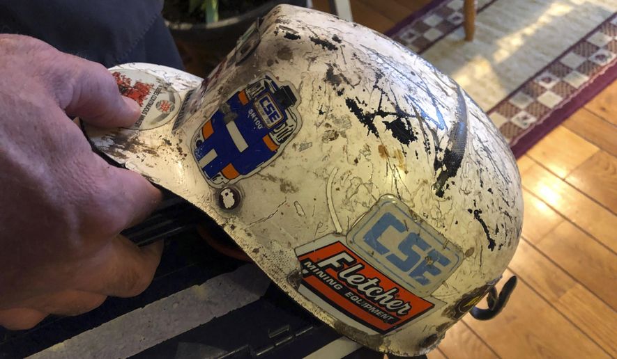 Retired coal miner John Robinson displays his mining helmet at his home in Coeburn, Va., on Thursday, Jan. 24, 2019. Robinson was 47 when he was diagnosed with black lung disease, part of a new generation of black lung sufferers who are contracting the deadly disease at younger ages. (AP Photo/Dylan Lovan)