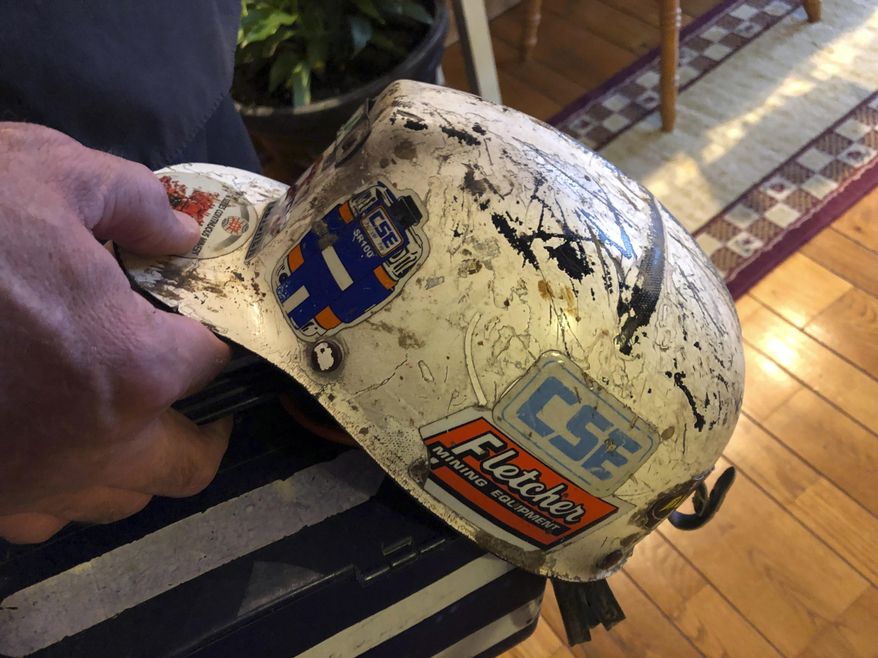 Retired coal miner John Robinson displays his mining helmet at his home in Coeburn, Va., on Thursday, Jan. 24, 2019. Robinson was 47 when he was diagnosed with black lung disease, part of a new generation of black lung sufferers who are contracting the deadly disease at younger ages. (AP Photo/Dylan Lovan)