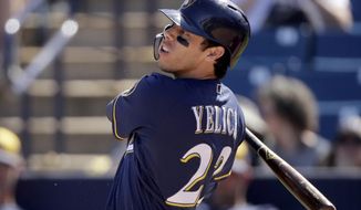 FILE - In this Sunday, March 3, 2019, file photo, Milwaukee Brewers&#39; Christian Yelich watches his RBI-double during the second inning of a spring training baseball game against the Cincinnati Reds in Phoenix. Yelich leads a versatile offense that bashed 218 homers last season, second in the NL to the Dodgers, and swiped 124 bases, tops in the league. (AP Photo/Charlie Riedel, File)