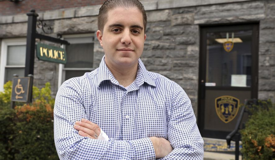 FILE - In this April 30, 2018 file photo, Irvington police officer Arcangelo Liberatore poses for a photo in Irvington, N.Y. Liberatore, who rescued a 5-year-old girl from a rabid coyote at a New York playground, is one of 19 people being honored with Carnegie Medals for heroism. (Tania Savayan/The Journal News via AP, File)