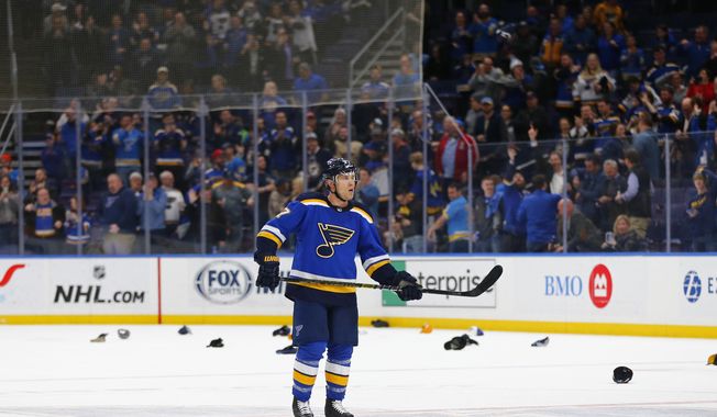 Fans throw their hats on the ice after St. Louis Blues&#x27; Jaden Schwartz (17) completed a hat trick against the Edmonton Oilers during the third period of an NHL hockey game Tuesday, March 19, 2019 in St. Louis. (AP Photo/Dilip Vishwanat)
