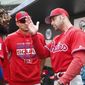 Philadelphia Phillies center fielder Odubel Herrera, left, and Philadelphia Phillies manager Gabe Kapler, right, talk in the dugout in the fourth inning during an exhibition spring training baseball game against the St. Louis Cardinals on Monday, March 18, 2019, in Jupiter, Fla. (AP Photo/Brynn Anderson)