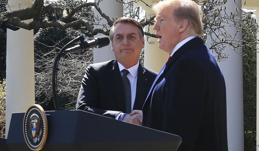 President Donald Trump and visiting Brazilian President Jair Bolsonaro shake hands as they conclude a news conference on the Rose Garden of the White House, Tuesday, March 19, 2019, in Washington. (AP Photo/Manuel Balce Ceneta)