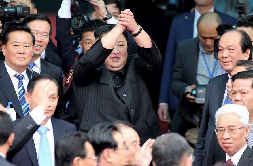 According to a report from the U.N. Security Council panel of experts reveals details about cyberattacks from the regime of North Korean leader Kim Jong-un (center). The attacks were used to evade financial sanctions. (Associated Press)