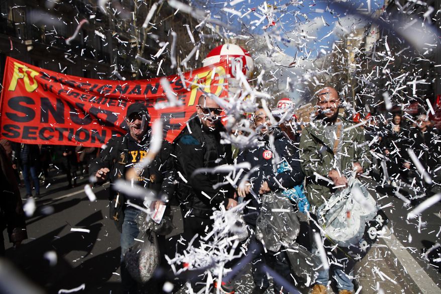 Unionists demonstrate as part of a national day of strikes in Paris, France, Tuesday, March 19, 2019. Several unions for education workers, private and public sectors called for demonstrations to protest they say low spending power. (AP Photo/Francois Mori)