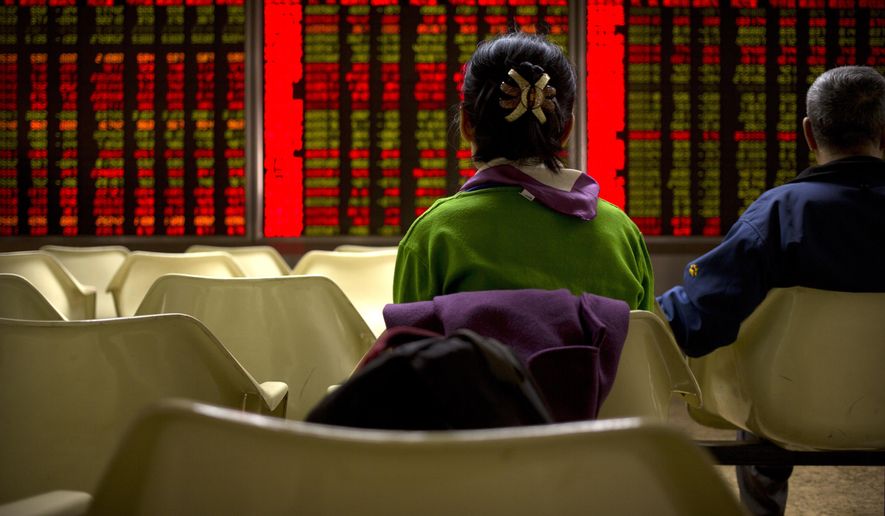 Chinese investors monitor stock prices at a brokerage house in Beijing, Wednesday, March 20, 2019. Markets in Asia are mostly lower after a lackluster day of trading on Wall Street.(AP Photo/Mark Schiefelbein)