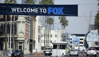 Cars enter and leave Fox Studios, Tuesday, March 19, 2019, in Los Angeles. Disney has closed its $71 acquisition of Fox’s entertainment business on Wednesday, March 20, in a move set to shake up the media landscape. The closure paves the way for Disney to launch its streaming service, Disney Plus, due out later this year. (AP Photo/Chris Pizzello)