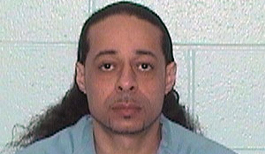 FILE--This undated booking file photo released by Illinois Department of Corrections shows Floyd E. Brown. Brown has pleaded not guilty in a federal case accusing him of fatally shooting a sheriff's deputy who was trying to serve an arrest warrant at a hotel. Brown of Springfield appeared in Rockford federal court Wednesday, March 20, 2019 sitting in a wheelchair and wearing green jail scrubs. A grand jury Tuesday indicted him on murder and weapons charges.(Illinois Department of Corrections via AP,File)