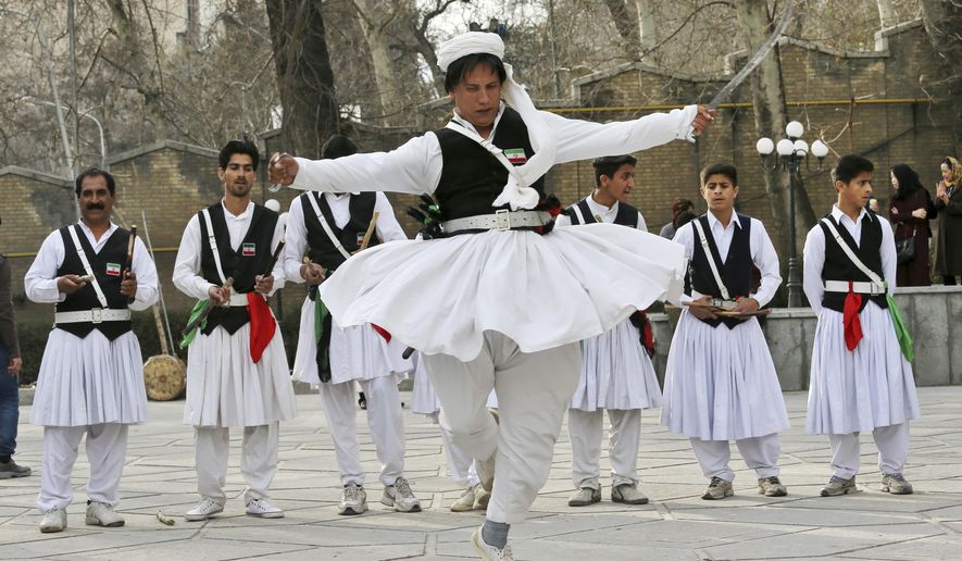 In this Wednesday, March 13, 2019 photo, a local dancer from Sistan-Baluchestan Province in southeastern Iran dressed in local attire performs ahead of the Iranian New Year, or Nowruz, meaning "New Day" in northern Tehran, Iran, to familiarize people with how they celebrate Nowruz in the region. The holiday, dating back to at least 1700 B.C. and ancient Zoroastrian traditions, is the most important event in the Iranian calendar and is widely celebrated forms across the territories of the old Persian empire, from the Mideast to Central Asia.(AP Photo/Vahid Salemi)