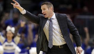 FILE - In this Thursday, March 14, 2019, file photo, Buffalo head coach Nate Oats yells instruction to players during the first half of an NCAA college basketball game against Akron at the Mid-American Conference tournament in Cleveland. Buffalo showing signs of shedding college basketball’s mid-major label in preparing to make fourth NCAA Tournament appearance in five years.  (AP Photo/Tony Dejak, File)