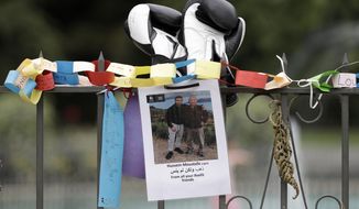 A tribute for mosque shooting victim Hossein Moustafa hangs on a wall at the Botanical Gardens in Christchurch, New Zealand, Thursday, March 21, 2019. Thousands of people were expected to come together for an emotional Friday prayer service led by the imam of one of the two New Zealand mosques where 50 worshippers were killed in a white supremacist attack on Friday March 15. (AP Photo/Mark Baker)