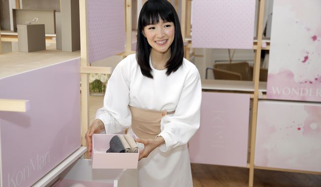 FILE- In this July 11, 2018, file photo, Japanese organizational expert Marie Kondo introduces her new line of storage boxes during a media event in New York. Kondo is sparking joy among shoppers feeling the urge to clean out their homes.But once you master the Japanese organizing expert’s novel approach to de-cluttering, what do you do with all the stuff you don’t want? (AP Photo/Seth Wenig, File)