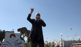 Turkey&#39;s President Recep Tayyip Erdogan speaks in front of a model dinosaur during the inauguration of a theme park in Ankara, Turkey, Wednesday, March 20, 2019. Erdogan has sparked a diplomatic spat with New Zealand and Australia as he campaigns for votes in local elections this month and portrays the mosque shooting in New Zealand and a World War I battle as targeting Islam.(AP Photo/Burhan Ozbilici)