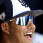 San Diego Padres&#39; Manny Machado laughs in the dugout prior to the team&#39;s spring training baseball game against the Milwaukee Brewers, Wednesday, March 20, 2019, in Peoria, Ariz. (AP Photo/Matt York)