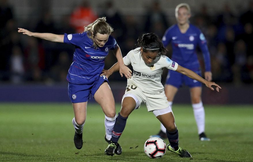 Chelsea Women's Erin Cuthbert, left, in action with Paris Saint-Germain Women's Perle Morroni during their Women's Champions League quarter final first leg match at the Cherry Red Records Stadium in London, Thursday March 21, 2019. (Bradley Collyer/PA via AP)