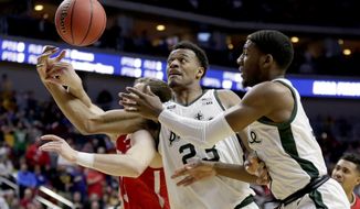 Bradley&#39;s Luuk van Bree, left, competes for a rebound against Michigan State&#39;s Xavier Tillman (23) and Aaron Henry, right, during the second half of a first round men&#39;s college basketball game in the NCAA Tournament in Des Moines, Iowa, Thursday, March 21, 2019. (AP Photo/Nati Harnik)