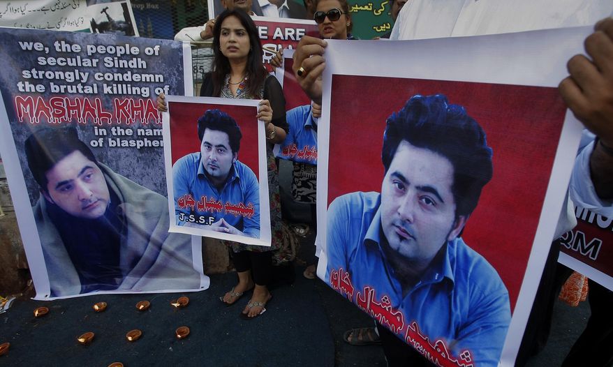 FILE - In this April 22, 2017 file photo, members of a Pakistani civil society group demonstrate against the killing of university student Mashal Khan, in Karachi, Pakistan. A court in northwest Pakistan sentenced two men to life in prison after they were found guilty of involvement in the death of Khan, a university student who was beaten and eventually shot to death by a mob after he was falsely accused of blasphemy. (AP Photo/Fareed Khan, File)