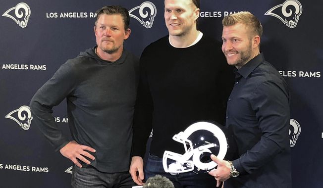Los Angeles Rams linebacker Clay Matthews, center, stands with general manager Les Snead, left, and coach Sean McVay at the NLF football team&#x27;s training complex in Thousand Oaks, Calif., Thursday, March 21, 2019. Matthews agreed to a two-year contract to return to his native Southern California with the Rams after playing for a decade with the Green Bay Packers. (AP Photo/Greg Beacham)