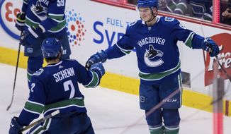 Vancouver Canucks&#39; Jake Virtanen, right, and Luke Schenn celebrate Virtanen&#39;s goal against the Ottawa Senators during the second period of an NHL hockey game Wednesday, March 20, 2019, in Vancouver, British Columbia. (Darryl Dyck/The Canadian Press via AP)