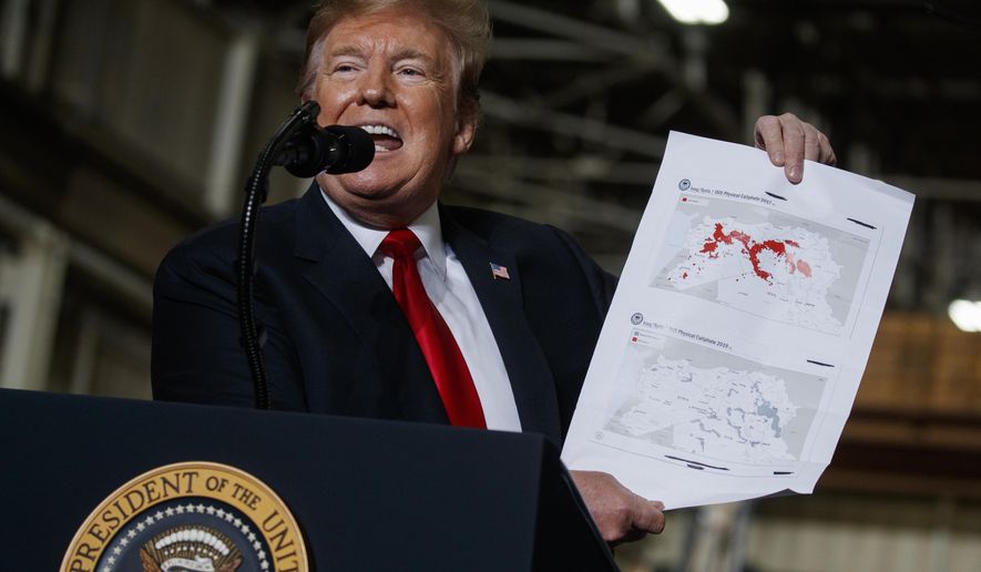 President Donald Trump holds up a chart documenting ISIS land loss in Iraq and Syria as delivers remarks at the Lima Army Tank Plant, Wednesday, March 20, 2019, in Lima, Ohio. In a campaign that spanned five years and two U.S. presidencies, the American military engineered the destruction of the Islamic State group’s self-proclaimed empire in Iraq and Syria. That’s a military success, but not one that’s certain to last. (AP Photo/Evan Vucci) **FILE**