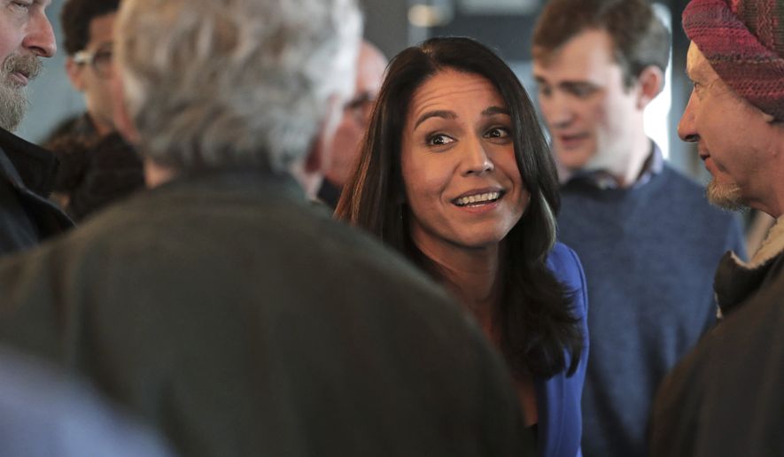 Presidential hopeful U.S. Rep. Tulsi Gabbard, D-Hawaii, greets guests during a gathering at a campaign stop at a brewery in Peterborough, N.H., Friday, March 22, 2019. (AP Photo/Charles Krupa)