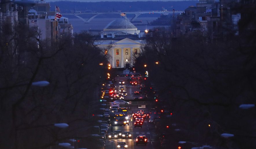 The American flag flies over the White House as vehicles move along 16th Street, in northwest Washington, Friday, March 22, 2019. (AP Photo/Pablo Martinez Monsivais) ** FILE **