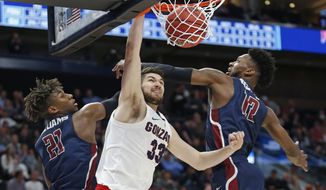 Gonzaga forward Killian Tillie (33) dunks between Fairleigh Dickinson&#39;s Elyjah Williams (21) and Kaleb Bishop (12) during the second half of a first-round game in the NCAA men’s college basketball tournament Thursday, March 21, 2019, in Salt Lake City. (AP Photo/Rick Bowmer)