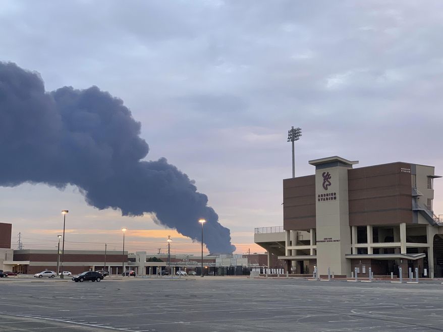 In this Tuesday, March 19, 2019 photo, shows smoke rising from a fire at the Intercontinental Terminals Company near the Deer Park School District's Abshire Stadium in Deer Park, Texas. Officials have lifted an order to remain indoors after several readings showed that the air quality had improved near a scorched petrochemical storage facility in suburban Houston. City officials in Deer Park lifted the order Thursday and reopened roads around the Intercontinental Terminals Company. But residents living near ITC say they're skeptical of what public officials are telling them. (Jeffrey Fountain via AP)
