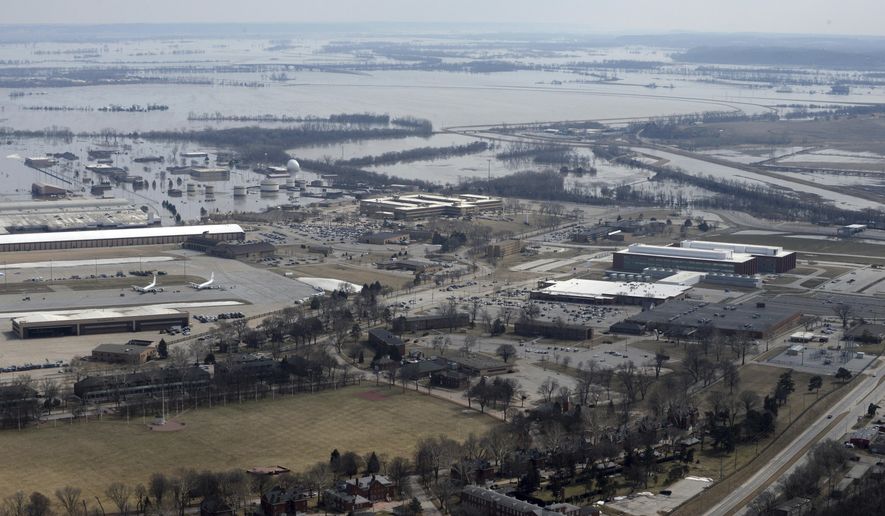 This March 17, 2019 photo released by the U.S. Air Force shows an aerial view of Offutt Air Force Base and the surrounding areas affected by flood waters in Neb. Surging unexpectedly strong and up to 7 feet high, the Missouri River floodwaters that poured on to much the Nebraska air base that houses the U.S. Strategic Command overwhelmed the frantic sandbagging by troops and their scramble to save sensitive equipment, munitions and aircraft. (Tech. Sgt. Rachelle Blake/The U.S. Air Force via AP)